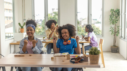 Young African girls are excited and happy by raising their hands to express their feeling in class. Hand celebration