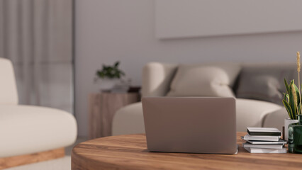 Laptop on minimal wood coffee table in cozy minimal home or apartment living room.