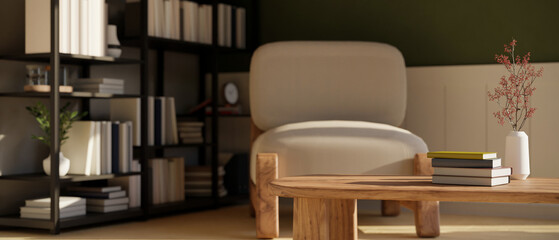 Cozy Scandinavian living room with bookshelf, comfy chair, copy space on wood coffee table © bongkarn