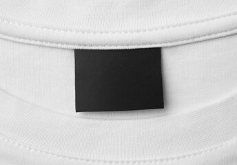 blank black color clothing label on white t shirt - obrazy, fototapety, plakaty