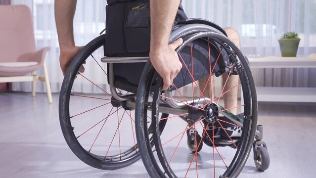 Close-up of hands holding a wheelchair.
Video of disabled person holding wheelchair.
