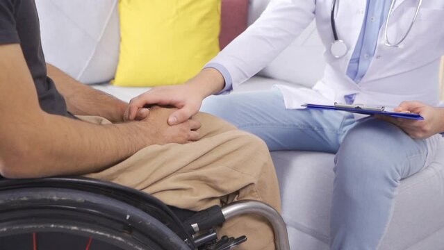 Hands of doctor giving morale to disabled patient in slow motion.
Disabled man talking to doctor in slow motion.
