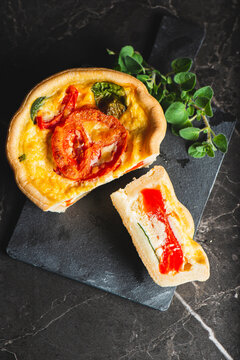 Freshly made and baked Vegetarian Quiche with spinach, capsicum, egg, and tomato