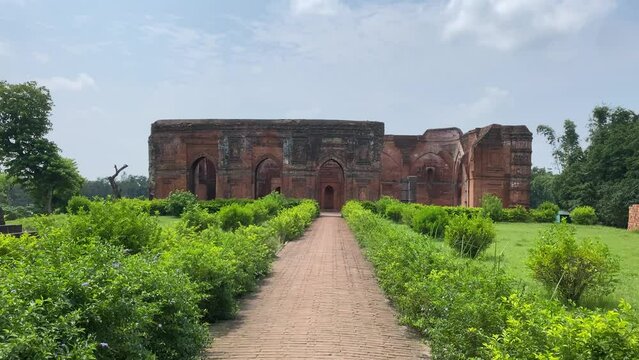 Cinematic shot of Tantipara Mosque at Gaur in Malda District in West Bengal. The mosque has an oblong structure made of bricks with two aisles of stone columns.