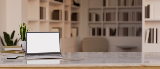 Minimal tabletop with laptop mockup and copy space over blurred reading room background © bongkarn