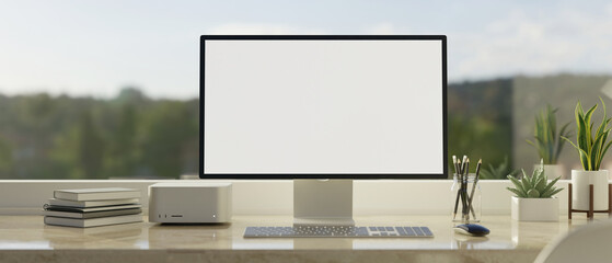 Computer screen mockup on white marble tabletop against the window with mountain view