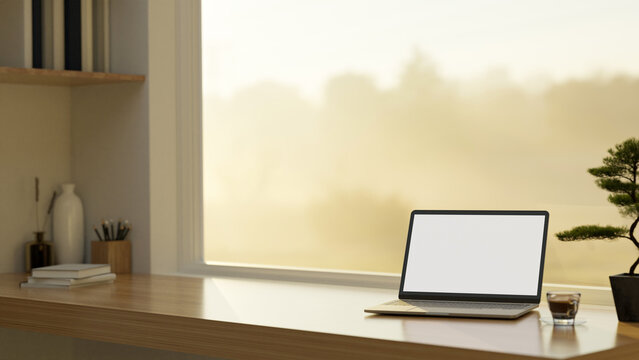 Home workspace with laptop mockup on wood tabletop against the window with nature view.
