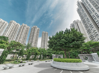 public park and high rise residential buildings in Hong Kong city © leeyiutung