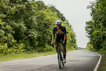 Fototapeta premium Groups of cyclists riding road bikes in the morning are climbing.