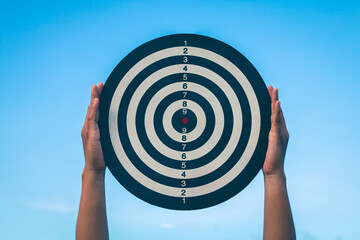 Bullseye has red dart arrow throw hitting the center of a shooting for business. targeting and winning goals business.