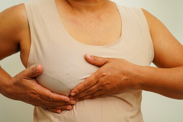 Asian woman self touching check lump or Breast cancer, Breast Self Exam.