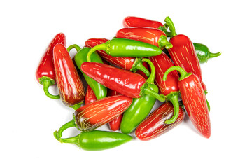 Harvested green and red jalapeno chilies lie together in a heap