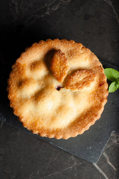 Freshly made and baked apple and blueberry pie with pastry leaves