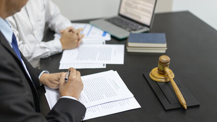 Lawyers or judges sign documents in accordance with legal and fair terms of agreement, Legal Ethics and Integrity, scales of justice, law hammer, Litigation and legal services.