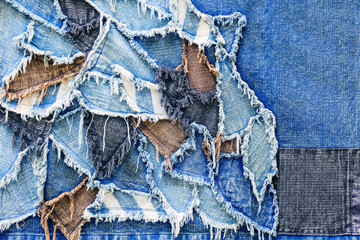 Ripped denim patch and destroyed torn denim blue scraps. Double color denim jeans fashion abstract background