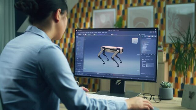 Asian woman working on pc in 3D modeling program remotely from home office and creating 3D prototype of modern robot
