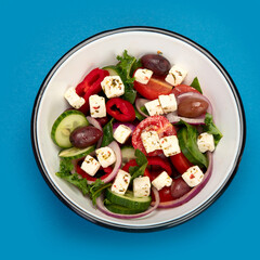 Greek salad  on color background.