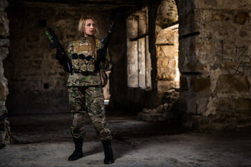 Blonde woman in army uniform holding a firearm in an abandoned building. 