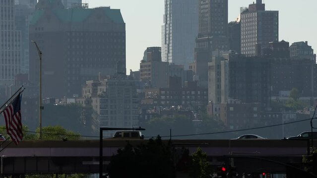 4K video with a lot of cars driving in rush hour traffic on East River Drive (FDR) highway street. Manhattan skyscraper office buildings in background. New York City, 2022.