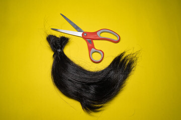 A lock of hair and scissors