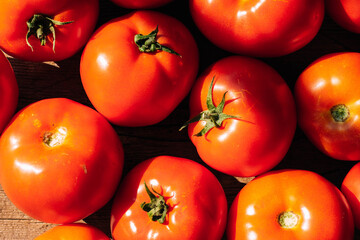 Organic food, harvest. Ripe red tomatoes lie on table