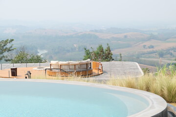 Exterior architecture and building design of Swimming pool and terrace patio with mountain view and blue sky- Thailand