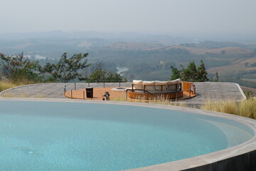 Exterior architecture and building design of Swimming pool and terrace patio with mountain view and blue sky- Thailand