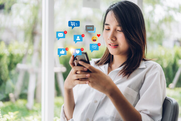 Portrait of happy asian woman relax use digital online technology social communication with phone.Young asian girl looking at phone screen with icon online icon social media