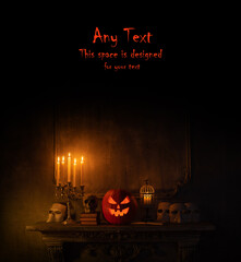 Halloween background with copy space for any text. Scary pumpkin and old skull on ancient gothic...