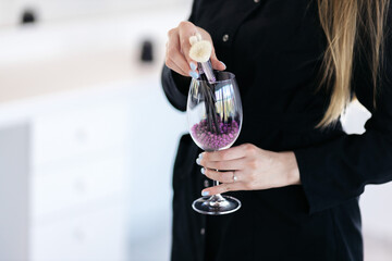 Makeup tools. Makeup concept. The girl is holding a glass in which there are brushes. Brushes for the face.