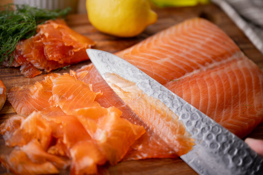 slicing gravlax, cured salmon, with knife