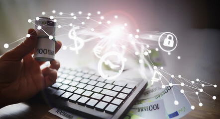 The work of a programmer and blogger on the Internet. Computer keyboard and a scattering of 100 euro bills on the table.