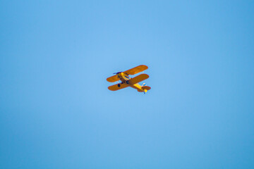 blue sky with clouds and yellow plane