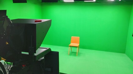 Interview chair in front of TV camera, in recording studio
