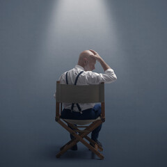 Disappointed filmmaker sitting on the director's chair