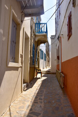 White houses with blue shutters, balconies, the traditional Greek village of Mandraki on the island of Nisyros.