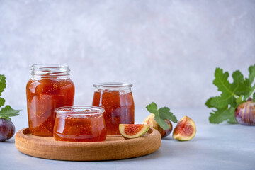 Fig jam in a glass jar and bowl. Fruits preserve