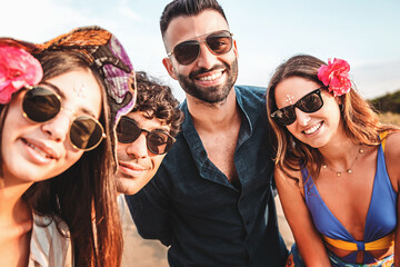 Portrait of happy friends with sunglasses looking at camera
