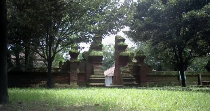 Red brick architecture of ancient old royal palace of Keraton Kasepuhan. Cirebon, West Java, Indonesia. mossy and worn red brick gate. right track