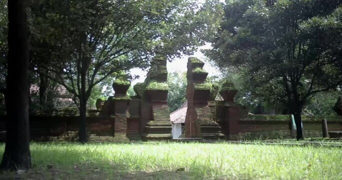 Red brick architecture of ancient old royal palace of Keraton Kasepuhan. Cirebon, West Java, Indonesia. mossy and worn red brick gate. left track