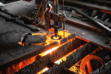 Oxygen torch cuts steel sheet. CNC gas cutting machine. Bright sheaf of sparks of molten metal