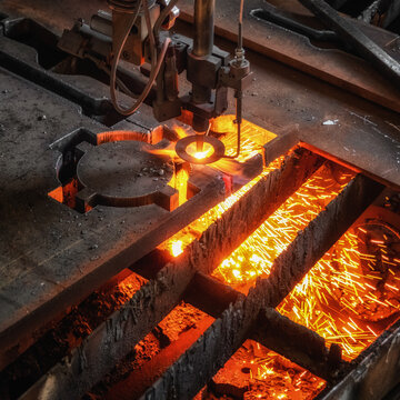 Oxygen torch cuts steel sheet. CNC gas cutting machine. Bright sheaf of sparks of molten metal