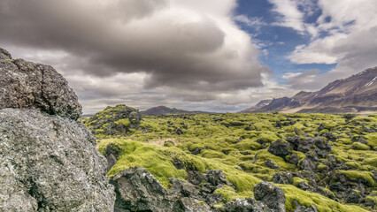 Lava fields stretching along the mountains in the north of Iceland, that all behind the rock