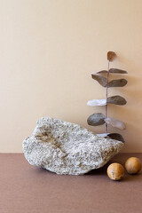 A stone podium on a beige background. Presentation of cosmetics. Mockup. Copy space.
