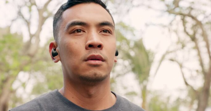 Fitness, earpods for music and training with workout, training and city background in nature or park exercise. Face zoom, sports or runner with wellness sport goal, motivation and radio podcast.