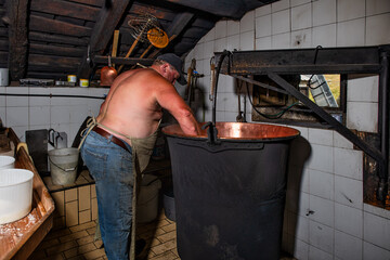 Inside a typical alpine hut in northern Italy the preparation of cheese