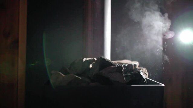 Steam coming off hot rocks in sauna