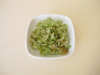 Dried hop flowers on a wooden board