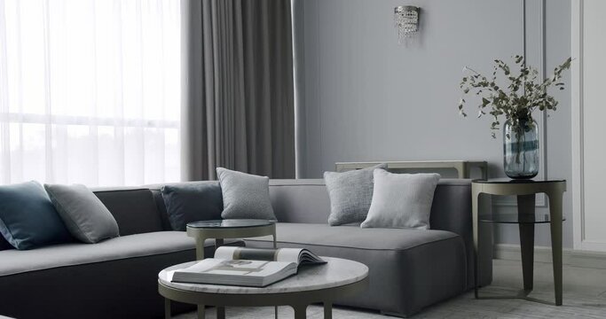 Modern contemporary Minimalist living room with gray furniture. Luxury Modern House Interior With Corner Sofa round table. Fashionable furniture. Minimalist Home Interior. Luxury Elegant Room