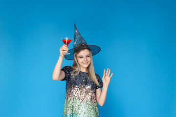 Concept of Halloween, young woman on blue background